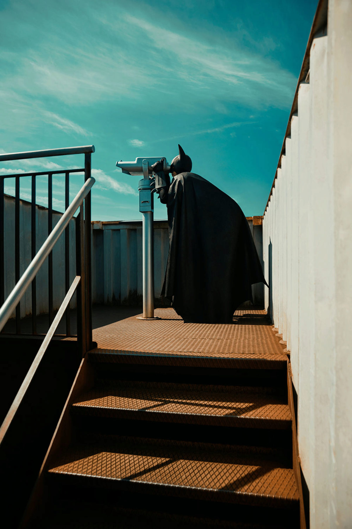 Batman looking through sightseeing binoculars